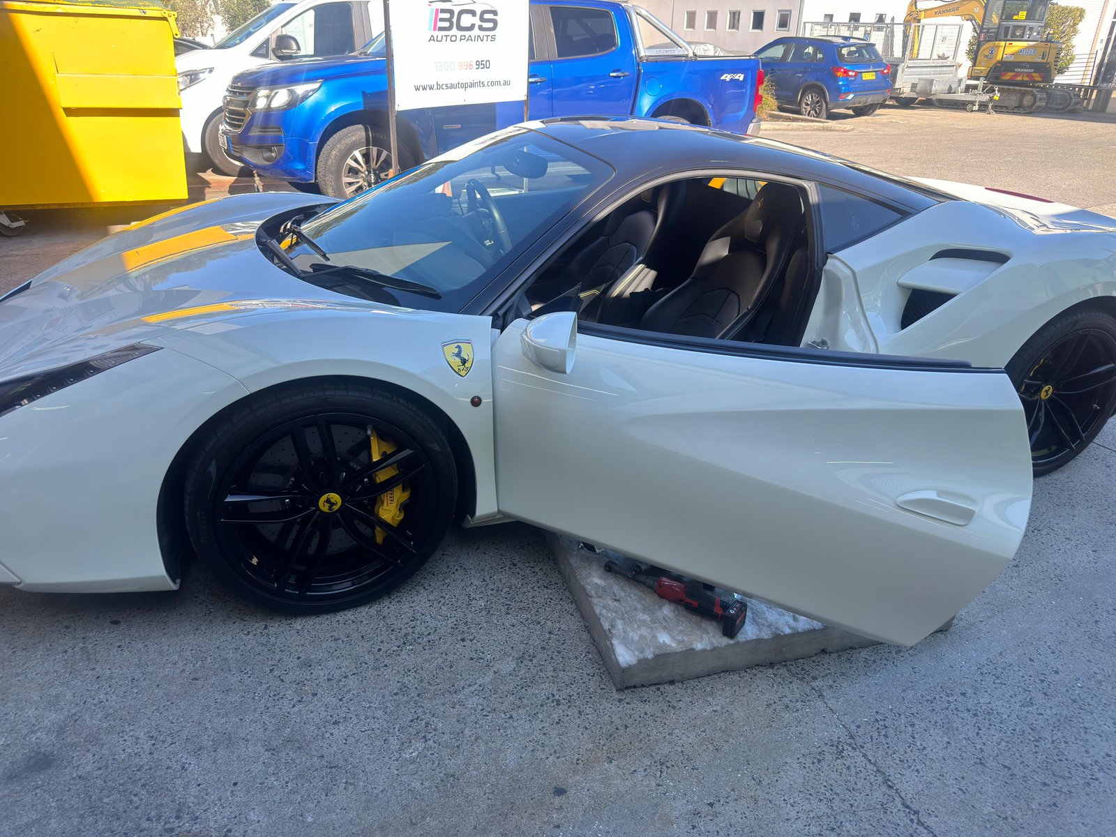 Luxury automotive service bay with professional battery service